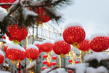 Red Chinese lanterns in snow. Chinese New Year. Chinese New Year holiday. Without people.