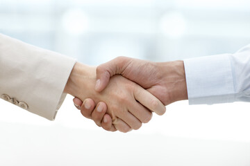 Business people, handshake and meeting for welcome, deal or agreement together at the office. Closeup, employees and shaking hands in b2b support, thank you or partnership with teamwork at workplace