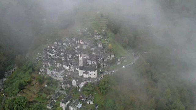 Drone footage of the iconic town of Corippo, Valle Verzasca, Switzerland, with a foggy charm.