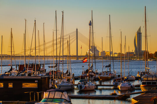Riga Kipsala yacht port and marina with Riga skyline in the background at early morning before the day of sailing starts full of parked yachts with sails down