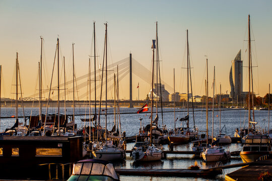 Riga Kipsala yacht port and marina with Riga skyline in the background at early morning before the day of sailing starts full of parked yachts with sails down