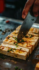 Slicing Tofu Block with Garnish on Cutting Board