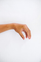 A hand making a pinching gesture, with the thumb and index finger close together, isolated on a plain white background. Ideal for concepts of holding, precision, or measurement.