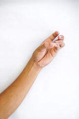A hand making a pinching gesture, with the thumb and index finger close together, isolated on a plain white background. Ideal for concepts of holding, precision, or measurement.