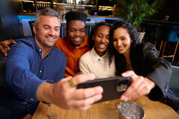 Black and Caucasian colleagues taking a photo together