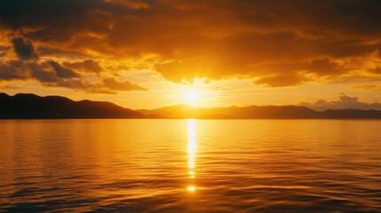 Obraz premium A majestic sunrise over a tranquil sea, with golden sunlight reflecting on the water, representing the promise of a new start