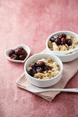 Homemade pudding with warm cherries and coconut