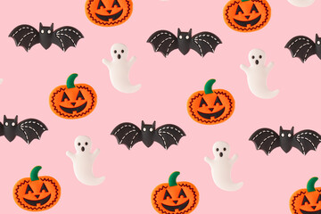 Smiling pumpkin, ghost and black bat on pink background. Funny Halloween celebration party idea.