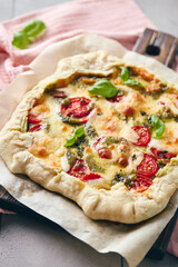Puff pastry tart pizza with tomatoes, mozzarella cheese and pesto sauce. Galette Caprese