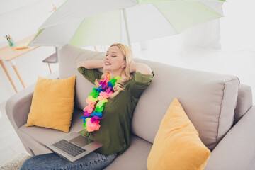 Photo of attractive charming woman sit sofa hold arms behind head dream summer vacation relax rest...