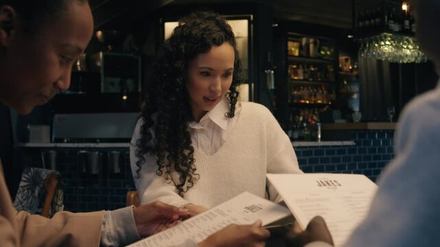 African and Caucasian friends looking at the menu to see what they would like to eat