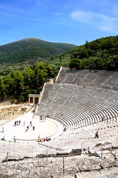 Panoramic view on a sunny summer day over the Ancient Theatre of Epidaurus in Greece, dedicated to the ancient Greek God of medicine, Asclepius. Holidays and sightseeing in Greece