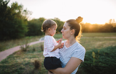 Fototapeta premium Toddler girl playing with mother
