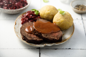 Roasted meat with red cabbage and potato dumplings