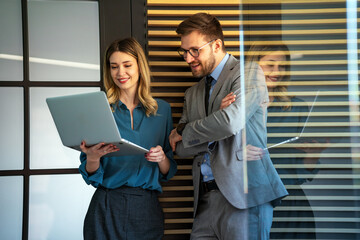 Multicultural professional businesspeople working together on research plan in boardroom.