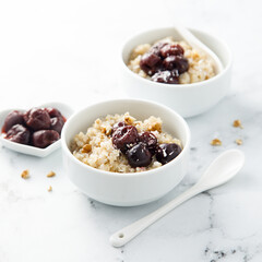 Homemade pudding with warm cherries and coconut