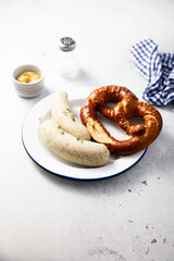 White sausages with salted pretzel