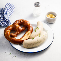 White sausages with salted pretzel
