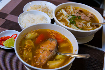 Finnish fish soup with red fish with spices and fresh dill on a dark stone background. Top view with copy space.. Fish soup with red fish