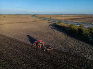 Tractor with plow, Farming with tractor and plow in field. Heavy agricultural machinery for field...