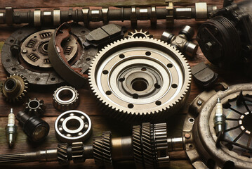 Car spare parts on the wooden workbench background. Top view.