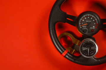 Sport car tuning equipment and spare parts on red top view background with copy space. Motorsport...