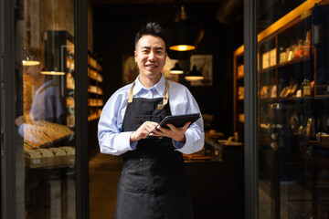 Chocolate store manager with tablet