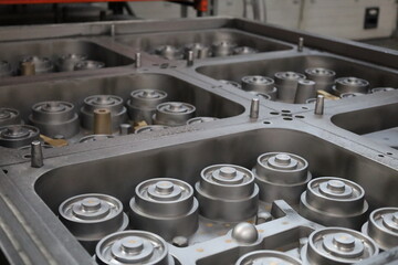 Metal industrial components arranged in a large mold for manufacturing. Engineering and machinery production process. Factory assembly line concept