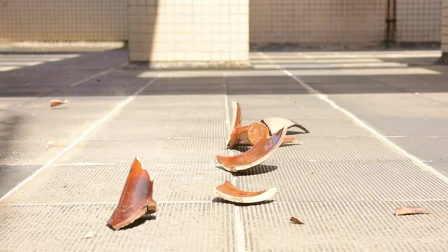 Slow motion of a herb medicine enamel pot falling to the ground