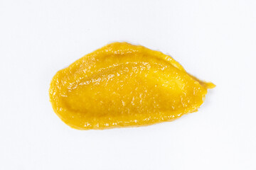 Smear of mustard sauce on white background isolate, creativity in cooking, macro texture
