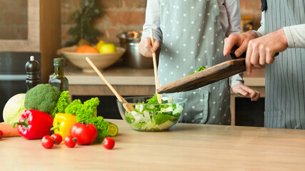 Family Cooking. Cheerful Dad And Little Daughter Preparing Healthy Lunch Together, Adding Vegetables To Salad, Caring Father Teaching Cute Girl How To Cook, Having Fun At Home Together, Copy Space