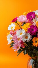 Vibrant bouquet of colorful daisies and gerberas in glass vase against bright orange background, creating a cheerful and energetic floral arrangement.