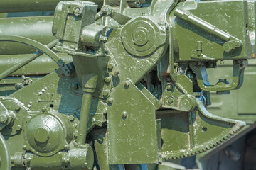Supplies of weapons for Ukraine. Ukrainian artillery, detail of weapons Russian-Ukrainian war. Part of the weapon in close up. Military khaki coloring. Metal gun metal. New guns artillery