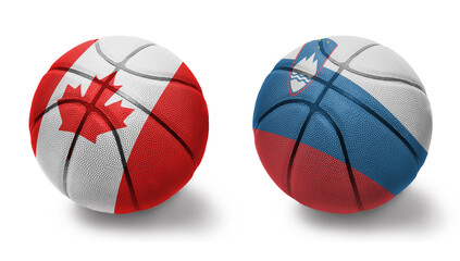 Fototapeta premium basketball balls with the national flags of slovenia and canada on the white background.