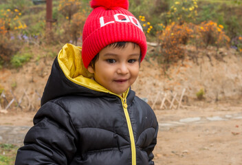 Happy baby portrait wearing warm clothes close up.