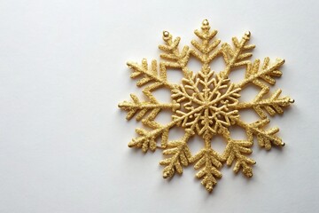 white surface flat lay with gold snowflake