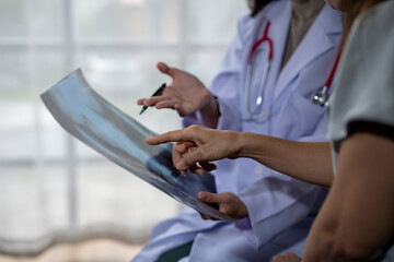 Two female doctors discussing about a radiography in a hospital room