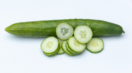 a whole and slices of cucumber on white background