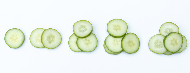Stacked slices of cucumber on white background