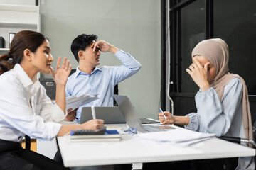 Businessman team working are under stress from financial data and report graph. Failed teamwork concept