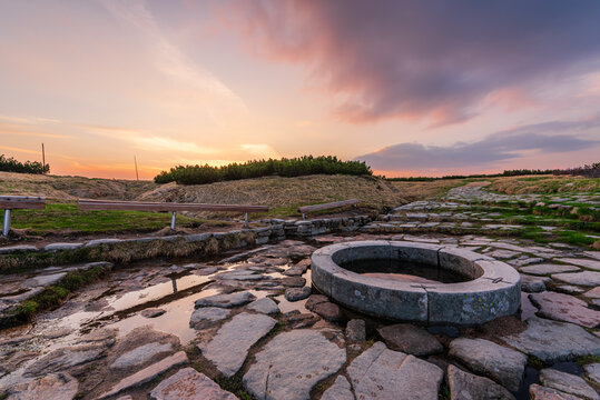 Source of the Elbe river in the Krkonose mountains in Czechia during sunset.