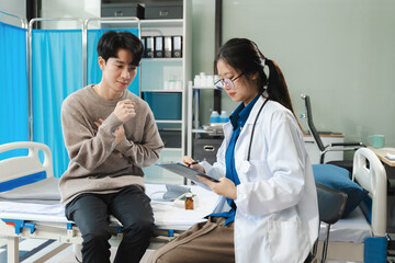 Fototapeta premium Doctor consulting patient filling form at consultation, talking to patient filling signing medical paper at appointment visit in clinic.