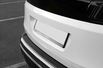 Fototapeta premium Closeup view of modern white car parked outdoors