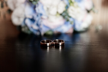 wedding gold rings on the table in the morning