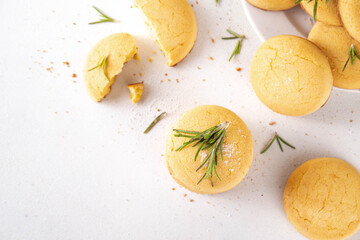 Savory rosemary and lemon shortbread cookies. Salted tasty cheese cookie appetizers with ingredients for cooking on white kitchen table