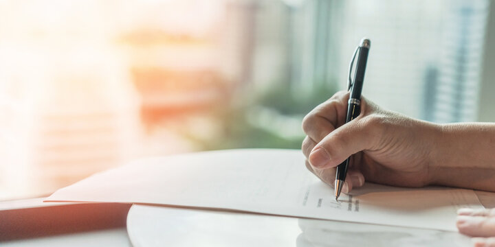 Business document signing for corporate agreements, work contracts, company partnerships, insurance, office deals or financial investments with hand of businessperson writing a signature on paperwork