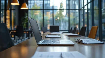 HR office workspace featuring a large table with laptops and documents. 