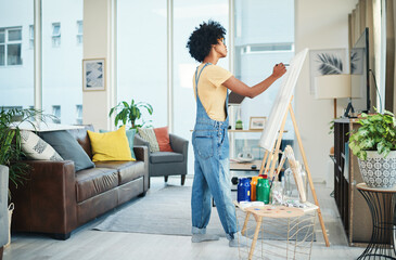 Art, canvas and painting with woman in living room of home for creativity, expression or...