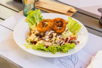 Delicious Salad With Chicken and Crispy Onion Rings