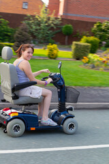 Young woman on mobility scooter enjoying the freedom the vehicle gives her to move independently...